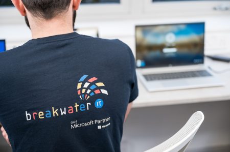 Breakwater IT Logo on T-Shirt with Windows Laptop in the Background