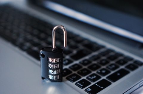 Laptop with an unlocked padlock on the keyboard