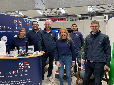 Breakwater IT and The Feed employees at an exhibition stand