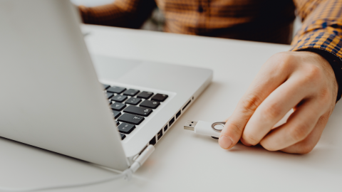 USB Stick being places into a laptop