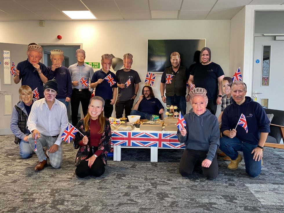 Employees dressed with Royal Family face masks with Andy, celebrating his anniversary and the Jubilee in 2022.