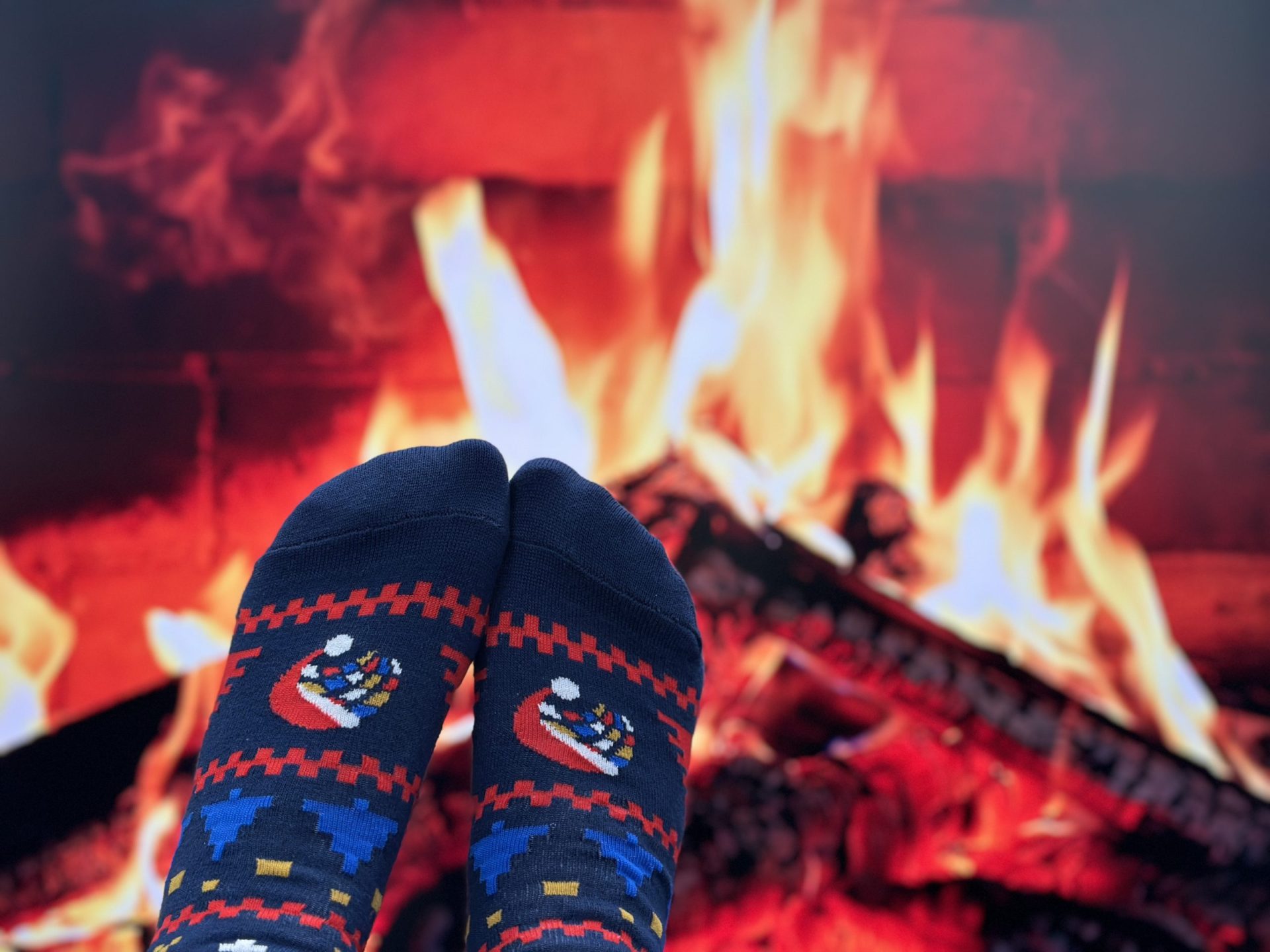 Breakwater Christmas socks in front of a fire.