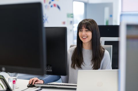 Jess working at her desk in the Breakwater office.