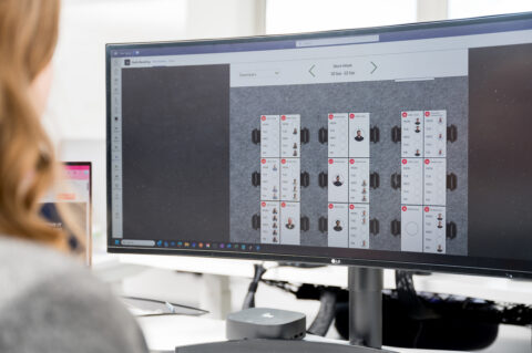 Wide Screen monitor showing Breakwater IT's desk booking application.