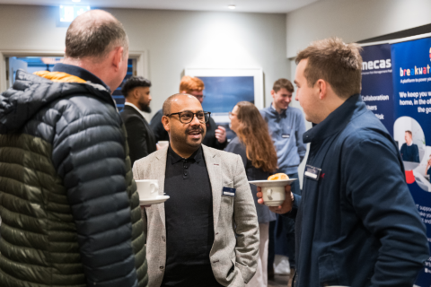 Attendees talking at a business networking event.