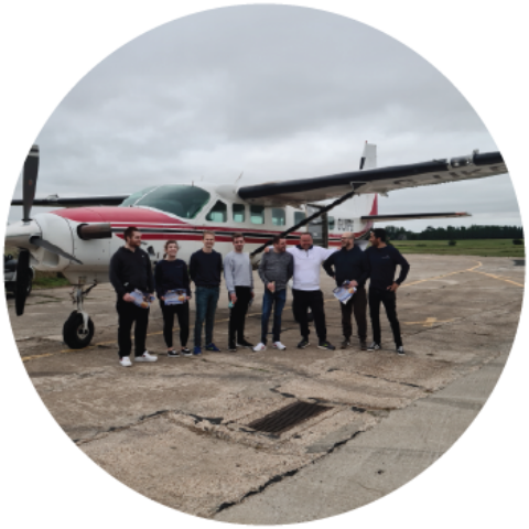Breakwater employees stood in front of a plane Breakwater employees stood in front of a plane