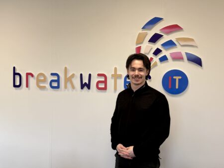 James Gooderham in front of the Breakwater IT logo